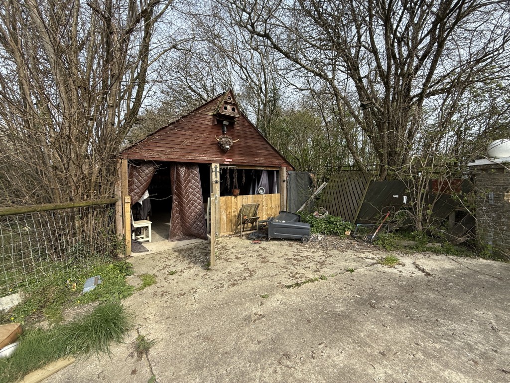Lot: 144 - DETACHED COTTAGE WITH OUTBUILDING AND STABLES ON A SITE MEASURING OVER SIX ACRES - Front of garage used as bar
